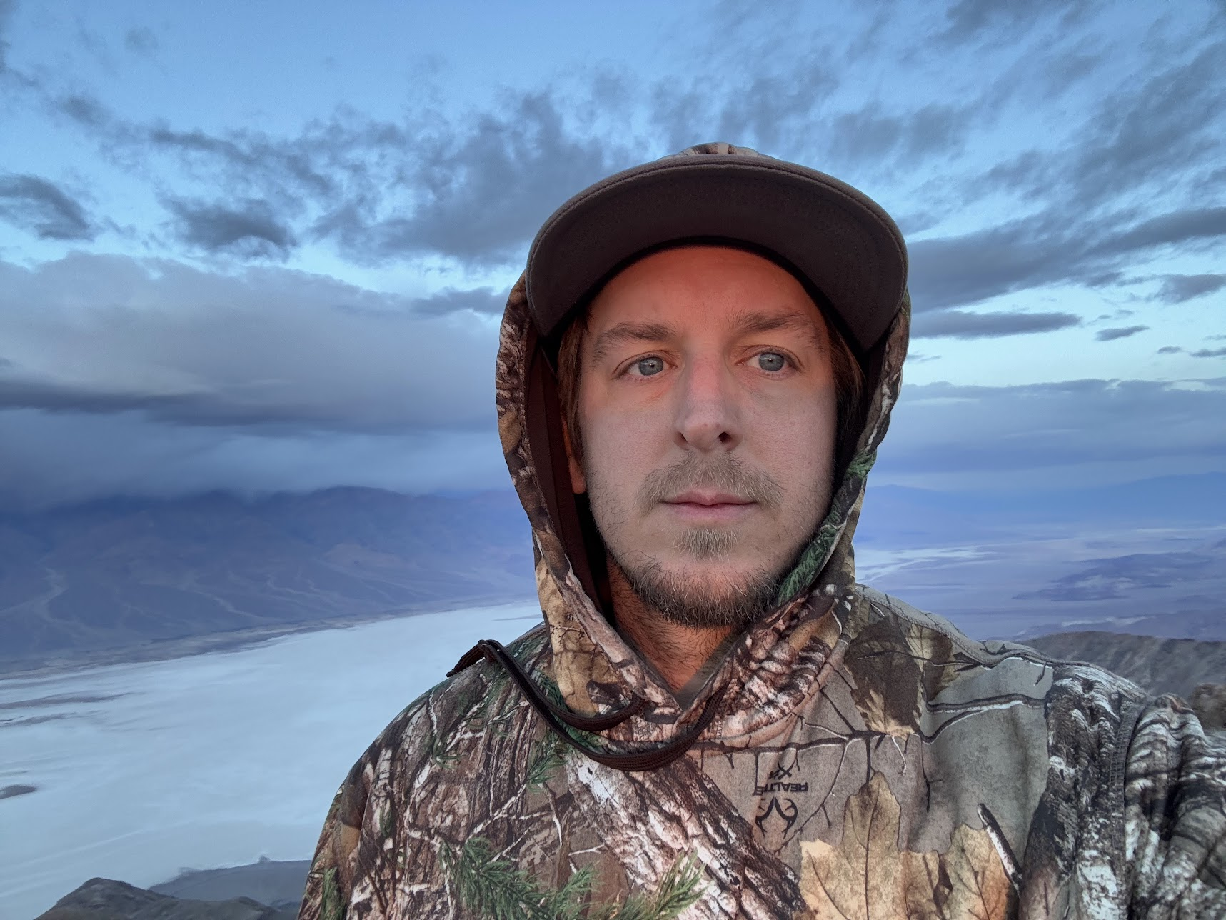 Stephen Abbott outdoors above a mountain lake